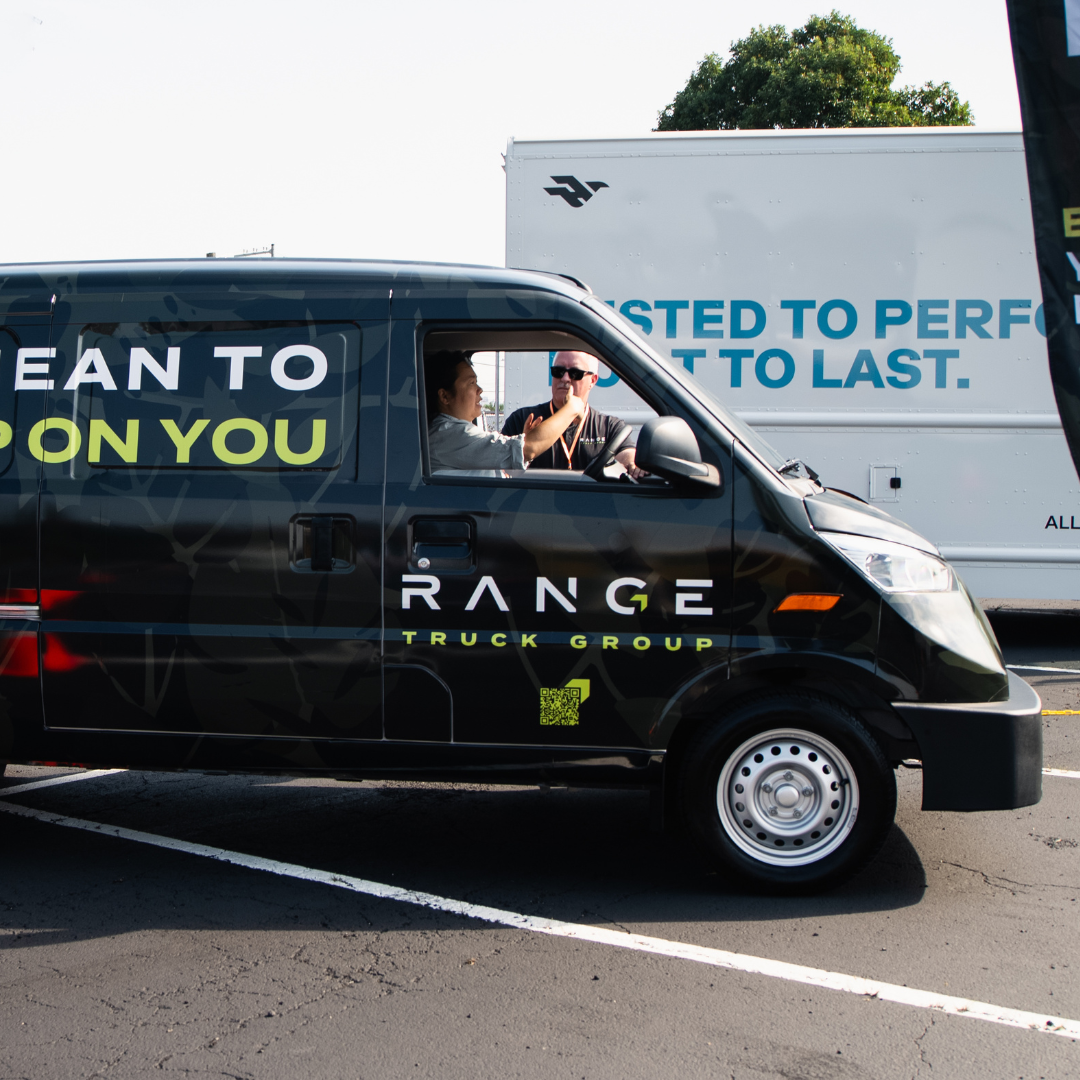 Fleet manager test driving electric van to evaluate EV performance and reduce fleet electrification risk before purchase